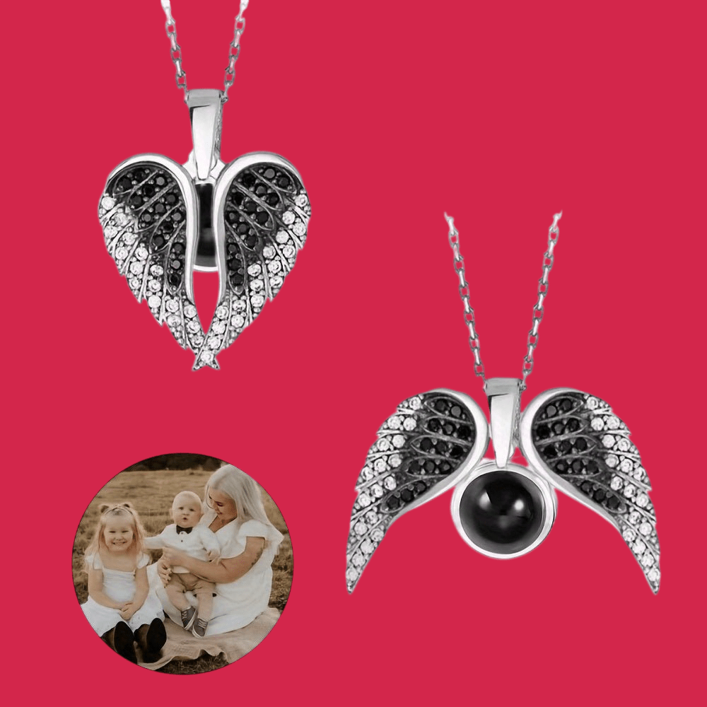 Two silver pendants with black stones on a red background, one featuring an angel wing design.