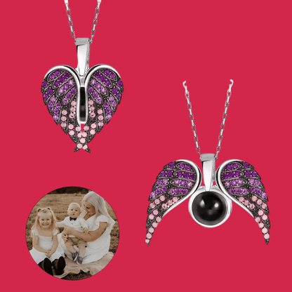 Two angel wing pendants with gemstones on a red background, one with a family photo inset.