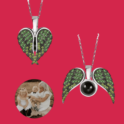 Two heart-shaped pendants with green gemstones on a red background, one featuring a black stone.